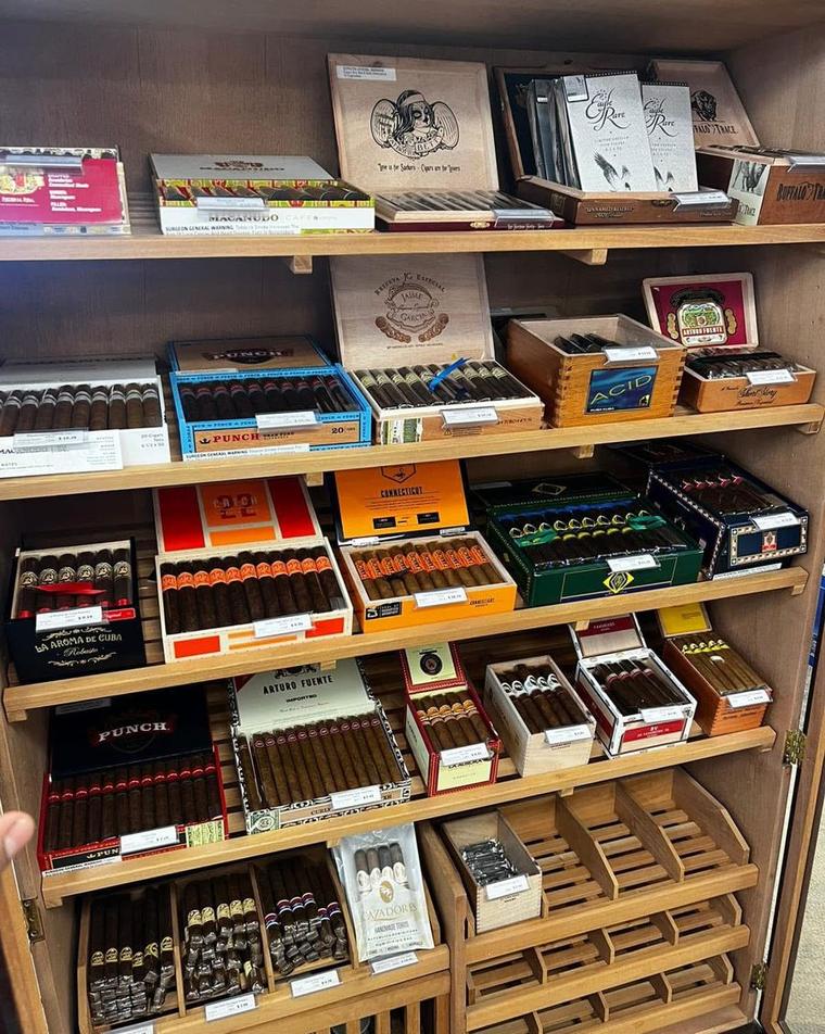 Cigar humidor at Pearl St. Liquor in Paola, Kansas, stocked with Macanudo, Punch, Arturo Fuente, Acid and other brands